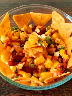 A picture of Mango salsa dip with nachos.