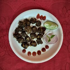 A picture of Banana flower pakora with tomato sauce.