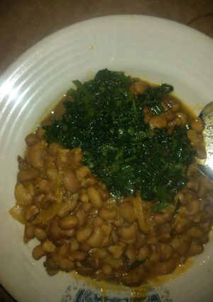 A picture of Joloff beans with green leaf stew.