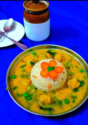 A picture of Yellow daal tadka with Soya chunks green peas.