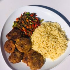 A picture of Spaghetti Bolognese and fish cake.
