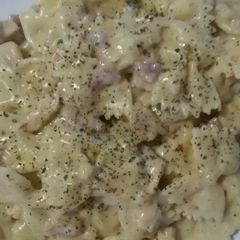 Chicken bacon and chorizo pasta bows in a white cheese sauce A picture of Chicken bacon and chorizo pasta bows in a white cheese sauce.