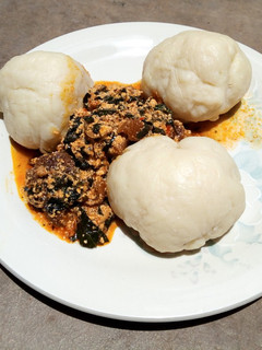 A picture of Pounded yam and bitter leaf soup.