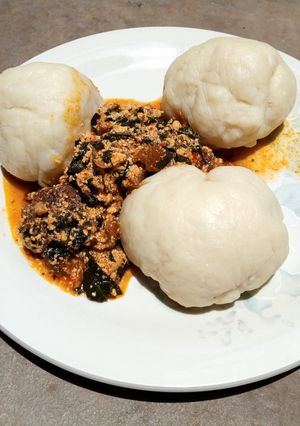 A picture of Pounded yam and bitter leaf soup.