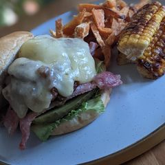 A picture of Father's Day sweet chilli beef burger and sweet potato fries.