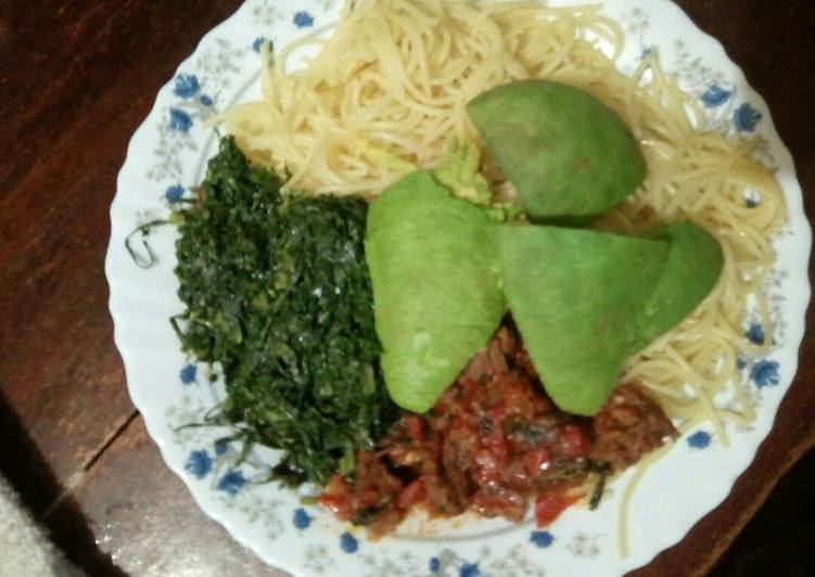 Spaghetti with meat stew and sukuma wiki