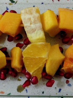 Una foto de Brochetas de frutas naranjas