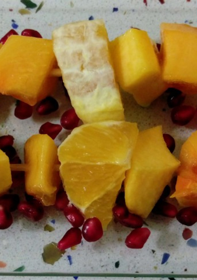 Una foto de Brochetas de frutas naranjas