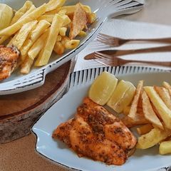 A picture of Oven baked salmon and chips.