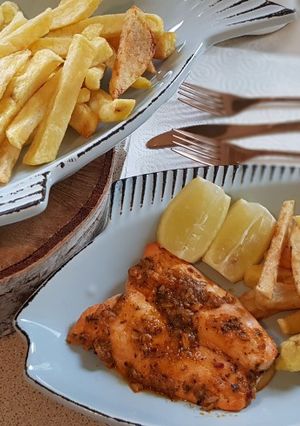 A picture of Oven baked salmon and chips.