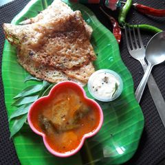 A picture of Vermicelli dosa with sambhar chutney.