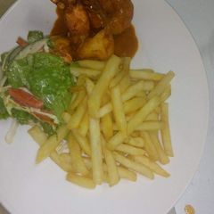 A picture of Jumbo prawns in tomatoes sauce with chips.