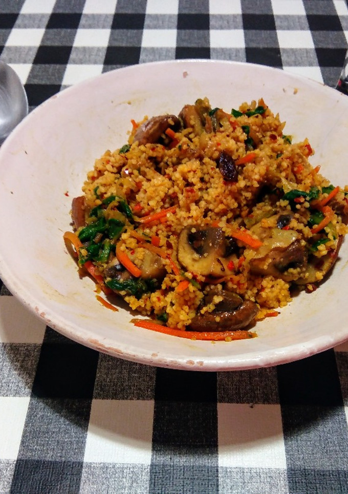 Una foto de Cous-cous con champiñones y verduras salteados en wok