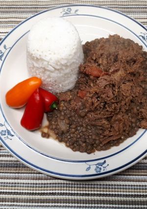 A picture of Lentils and shredded beef served with rice.