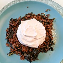 A picture of Kale with minced beef and garlic yogurt sauce.