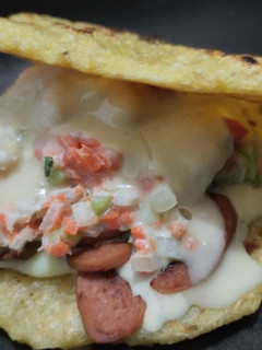 Una foto de Arepa🫓rellena de queso🧀salchicha🌭y ensalada🍅🧅🥕