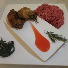 A picture of Rosemary chicken with spicy noodles and saute spinach.