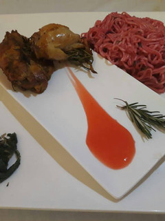 A picture of Rosemary chicken with spicy noodles and saute spinach.