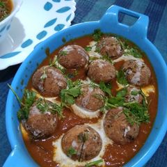 A picture of Paneer Koftas in Tomato Gravy.
