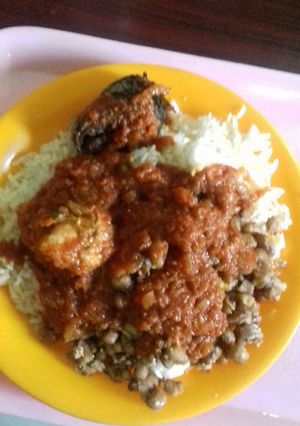 A picture of Rice, beans, stew with chicken and fish.