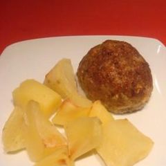 Mini meatloaves with potatoes in the oven A picture of Mini meatloaves with potatoes in the oven.