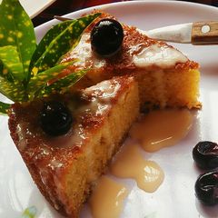A picture of Maize Malva Pudding drizzled with custard.