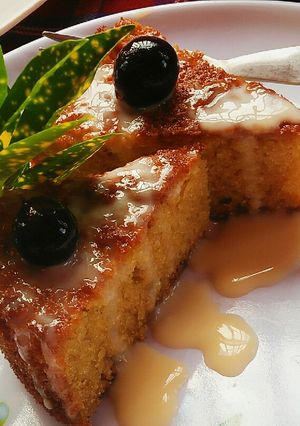 A picture of Maize Malva Pudding drizzled with custard.
