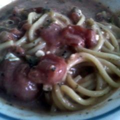 A picture of meatless garlic spaghetti with stewed tomatoes.