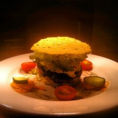A picture of Spinach Bacon Garlic Mouse In A Flat Mushroom With Breaded Goat Cheese.