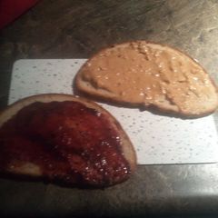 A picture of peanut butter and jelly on sunflower seed bread.