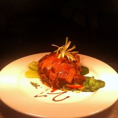 A picture of Confit Duck With Tai Noodle And Pac Choi.
