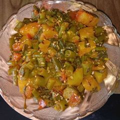 A picture of French beans, spring onions,potato sabji.