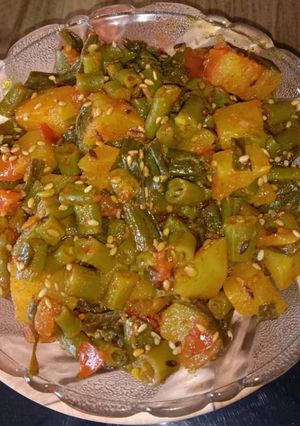A picture of French beans, spring onions,potato sabji.