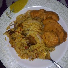 A picture of Jollof rice with moimoi.