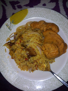 A picture of Jollof rice with moimoi.