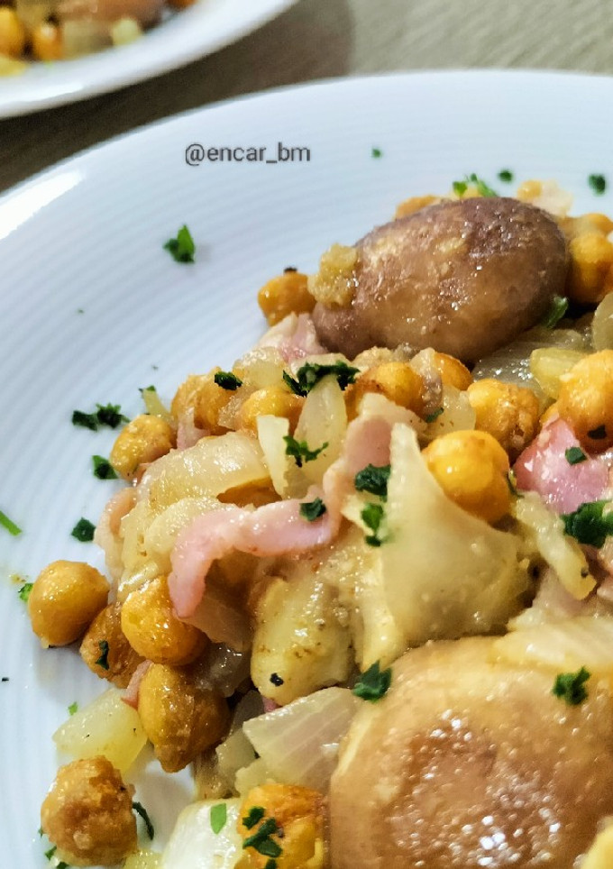Una foto de Salteado de garbanzos especiados con sofrito de setas, cebolla y bacon