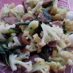 A picture of Stir fry cauliflower saussages and quail eggs.