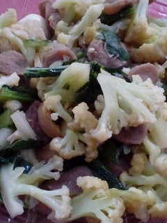 A picture of Stir fry cauliflower saussages and quail eggs.