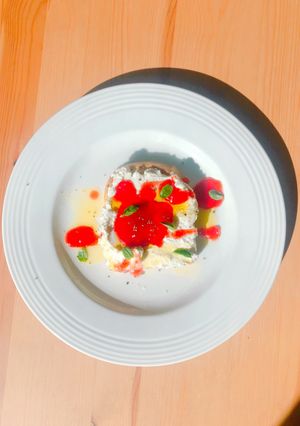 A picture of Ricotta and drunk strawberry open toast.