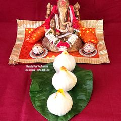 A picture of Ukadiche Modak - Steamed Rice Flour Dumplings Stuffed With Coconut Jaggery Sweet Mixture.