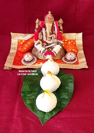 A picture of Ukadiche Modak - Steamed Rice Flour Dumplings Stuffed With Coconut Jaggery Sweet Mixture.
