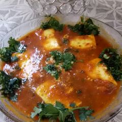 A picture of Paneer masala with tomato gravy.