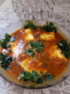 A picture of Paneer masala with tomato gravy.