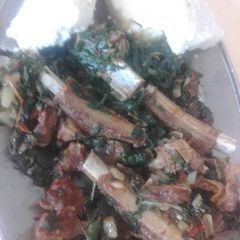 A picture of Mutton ribs mixed with spinach.