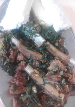 A picture of Mutton ribs mixed with spinach.