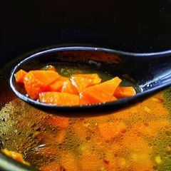 A picture of Carrot ginger clear soup.