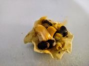 A picture of nachos with black beans