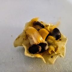 A picture of Black bean, corn and chicken nachos.
