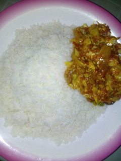A picture of Rice with vegetables soup.