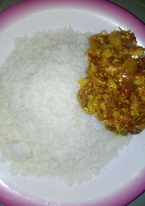 A picture of Rice with vegetables soup.